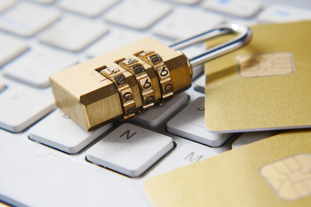 unlocked lock next to credit cards on keyboard