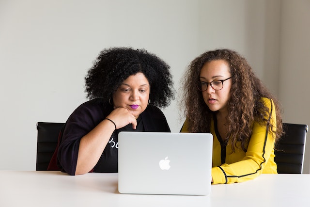 two women looking at online accounts