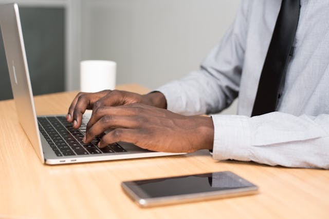 man typing at computer