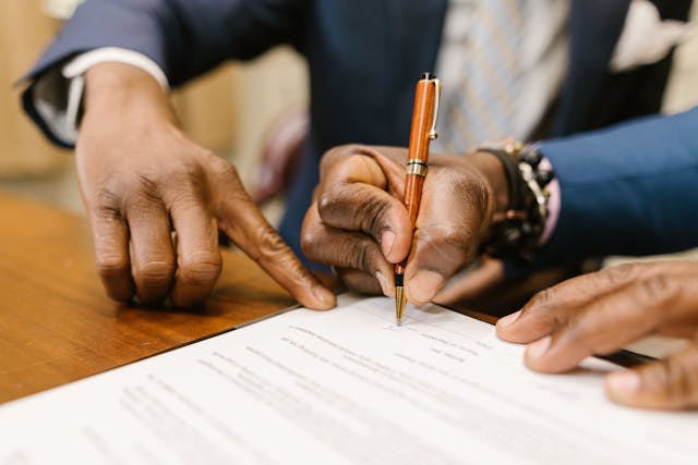 man signing paper