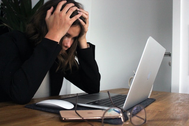 stressed woman holding head