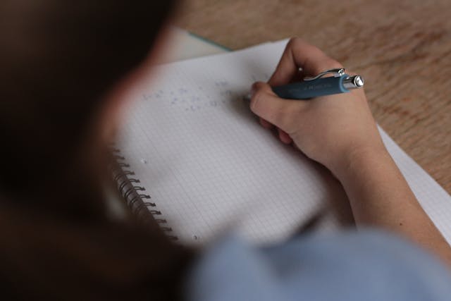 woman writing on table