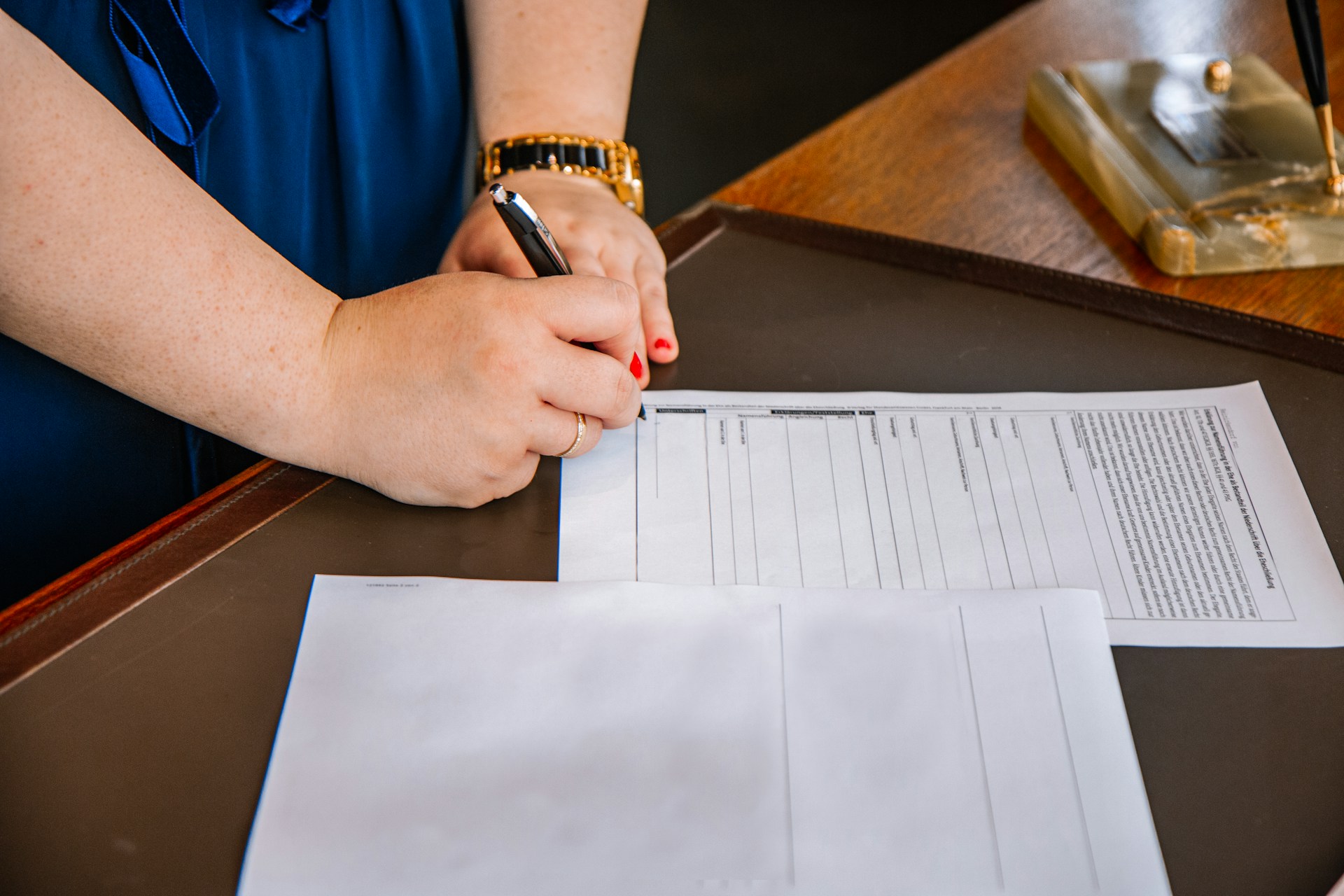 woman signing papers